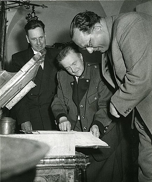 Bürgermeister Alfred Merlini, Kustodin Notburga Huiber und Unterrichtsminister Dr. Heinrich Drimmel vor geöffneter Bäckerlade im neuen Radkersburger Stadtmuseum, 1955. Foto: Steffen Lichtbild, Graz, MiaZ